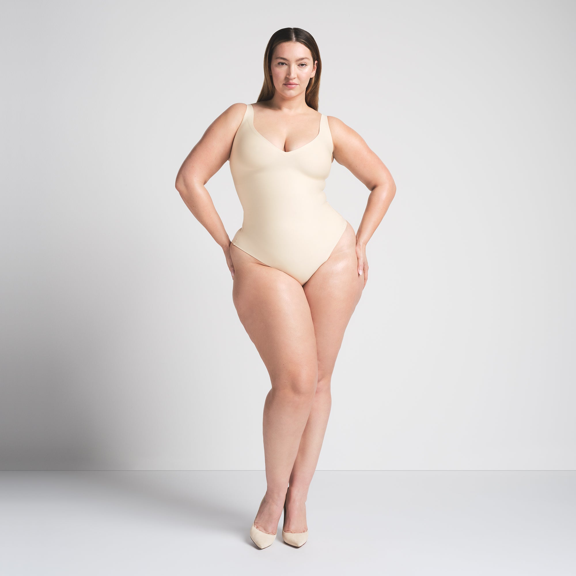 SKIMS BODY UNLINED PLUNGE THONG BODYSUIT | SAND